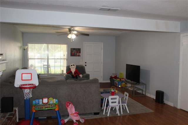 recreation room with visible vents, baseboards, ceiling fan, and wood finished floors