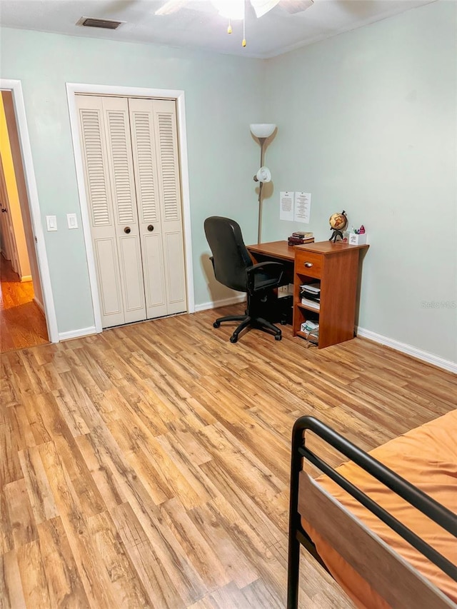 office space featuring visible vents, baseboards, wood finished floors, and a ceiling fan