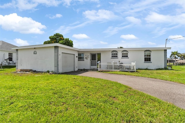 ranch-style house with a garage and a front yard