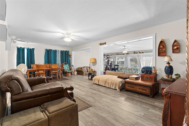 living room featuring ceiling fan and light wood-type flooring