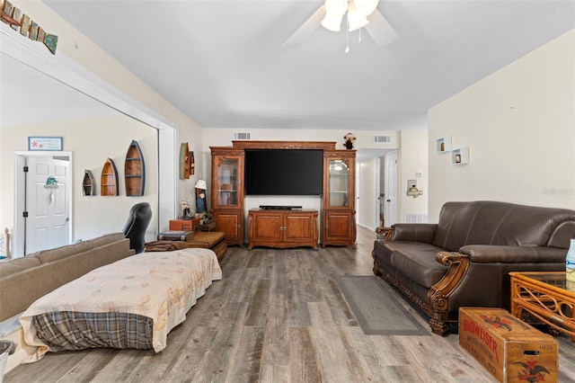 living room with hardwood / wood-style floors and ceiling fan