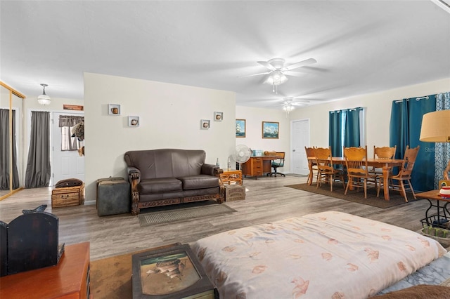 living room featuring light wood-type flooring and ceiling fan