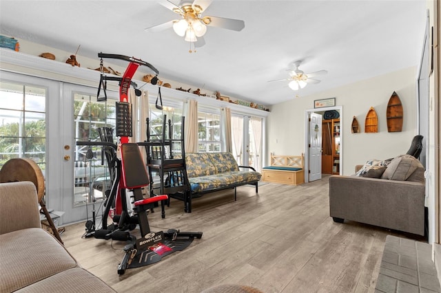 living room with french doors, lofted ceiling, ceiling fan, and light hardwood / wood-style floors