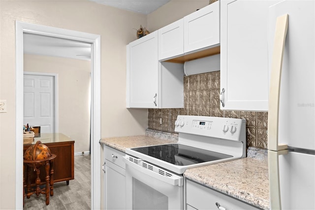 kitchen with backsplash, white appliances, white cabinetry, and light hardwood / wood-style floors