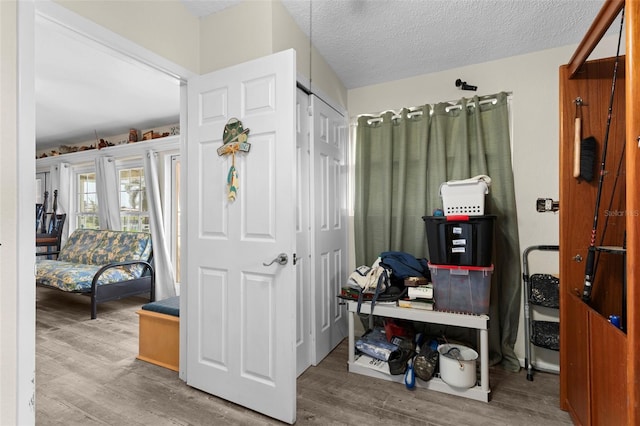 interior space with hardwood / wood-style flooring and a textured ceiling