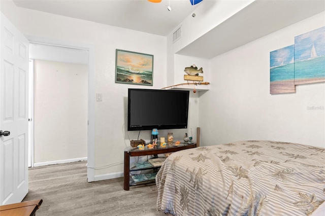 bedroom featuring ceiling fan and light hardwood / wood-style flooring