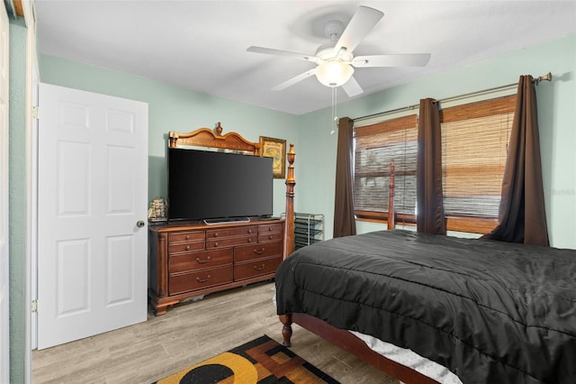 bedroom with ceiling fan and light hardwood / wood-style floors