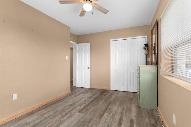 unfurnished bedroom with a closet, ceiling fan, and hardwood / wood-style floors