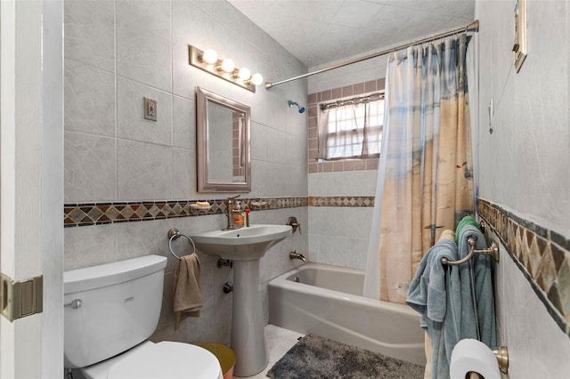 bathroom with tile walls, toilet, tile patterned floors, and shower / bath combo with shower curtain