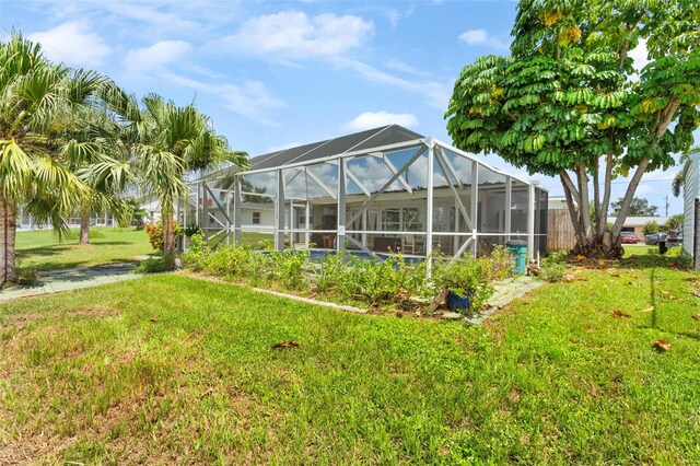 exterior space with a yard and a lanai