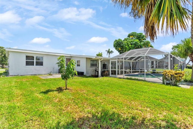 back of property featuring a yard and a lanai