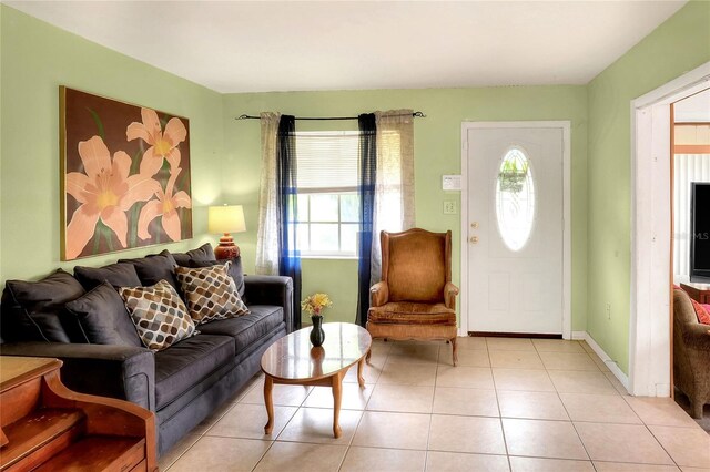 living room featuring light tile patterned floors and a healthy amount of sunlight