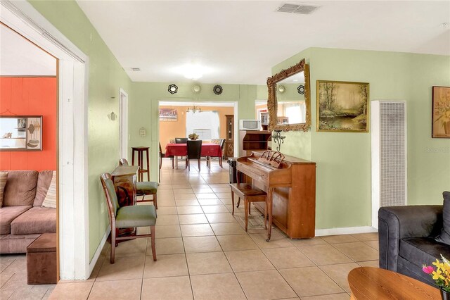 interior space with a notable chandelier and light tile patterned floors