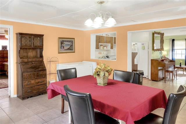 dining area featuring ornamental molding, light tile patterned floors, and a notable chandelier