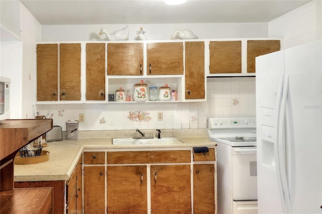 kitchen with sink, white appliances, and decorative backsplash