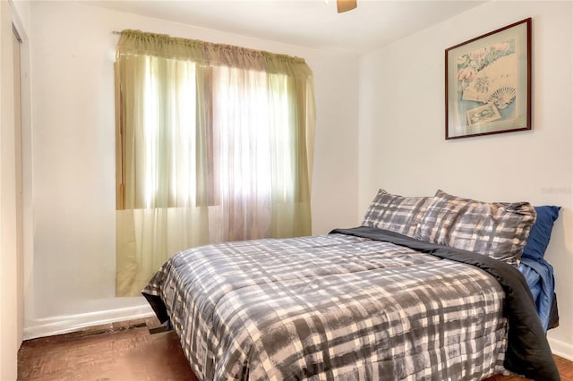 bedroom with ceiling fan and hardwood / wood-style flooring