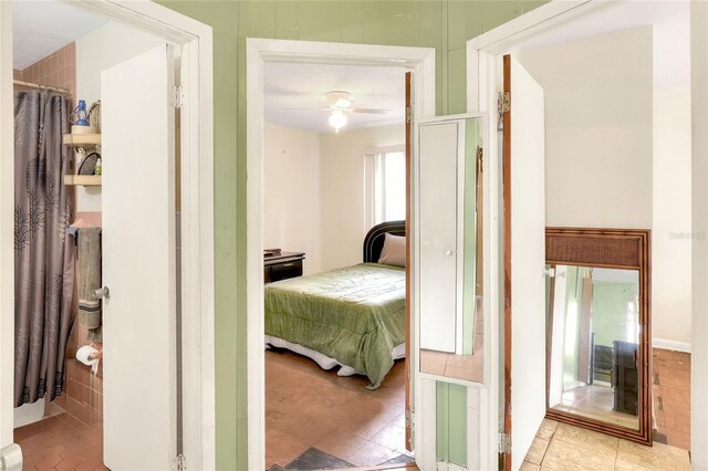 bedroom with ceiling fan and light tile patterned floors