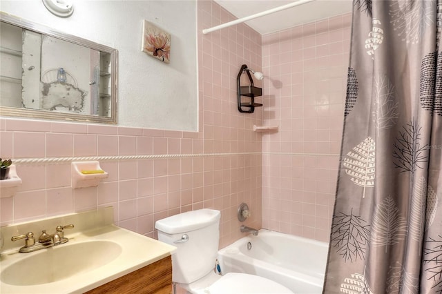 full bathroom featuring tile walls, shower / tub combo with curtain, vanity, and toilet