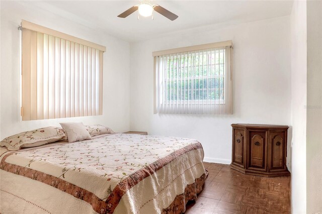 bedroom featuring parquet flooring and ceiling fan