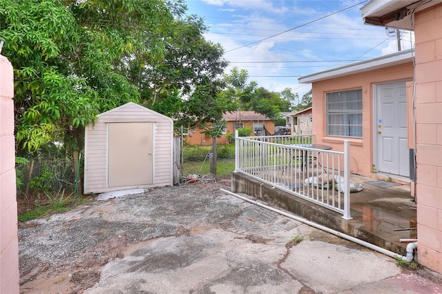 view of patio / terrace with a shed