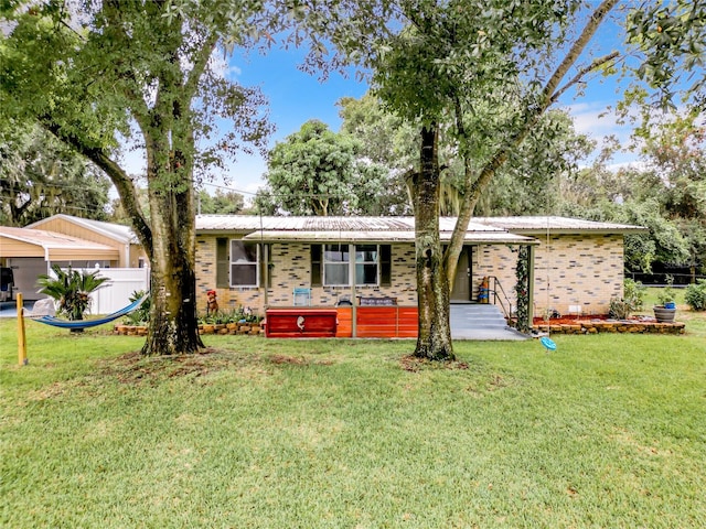 ranch-style home featuring a front yard