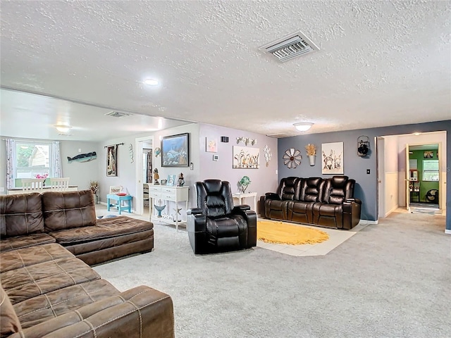 carpeted living room featuring a textured ceiling