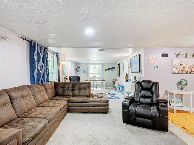 carpeted living room with a textured ceiling