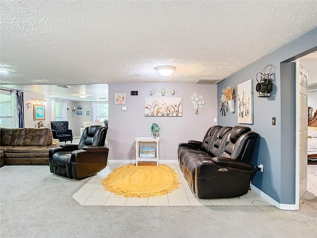 carpeted living room featuring a textured ceiling