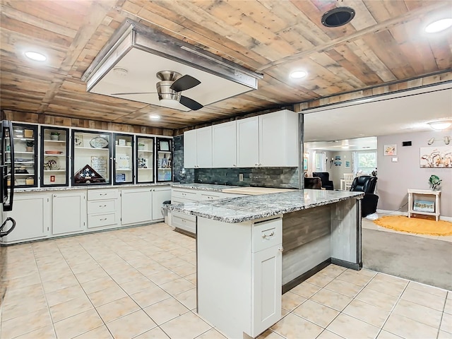 kitchen featuring ceiling fan, light stone counters, light tile patterned flooring, wood ceiling, and white cabinetry