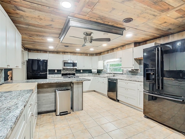 kitchen featuring ceiling fan, white cabinets, and stainless steel appliances