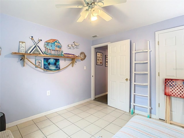 unfurnished bedroom featuring ceiling fan and light tile patterned floors