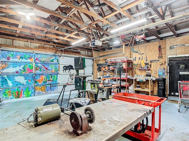 garage with a garage door opener and a workshop area