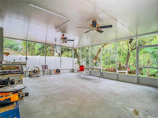 unfurnished sunroom featuring ceiling fan