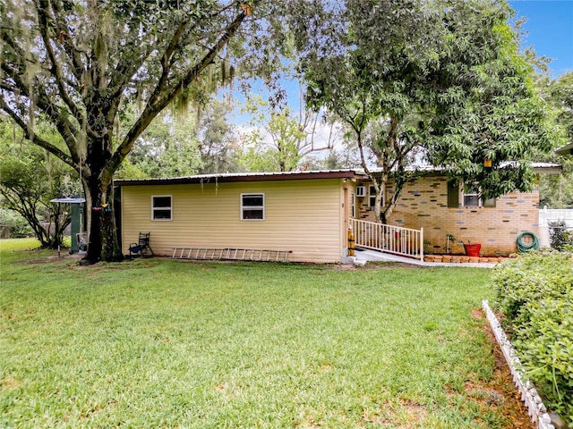 rear view of property with a yard