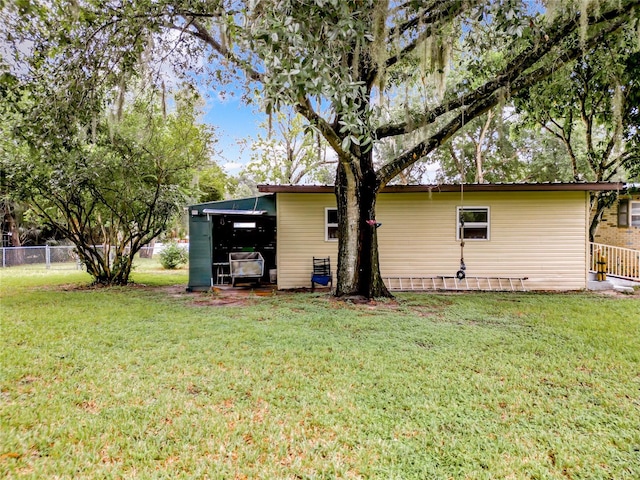 back of property featuring a lawn