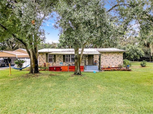 ranch-style home with a front yard and a carport