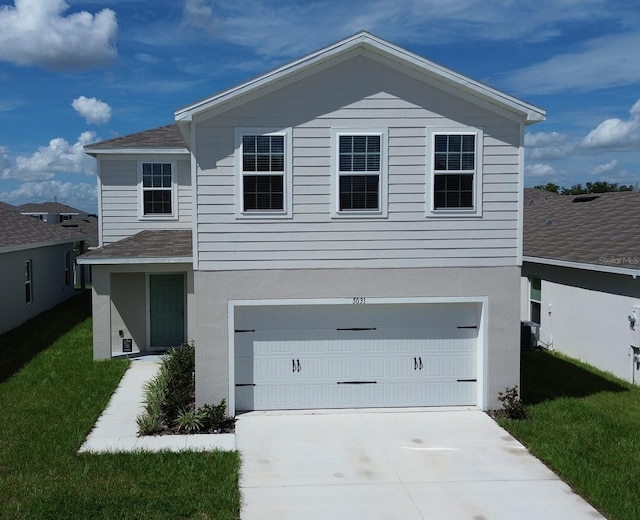 view of front facade with central air condition unit, a front yard, and a garage