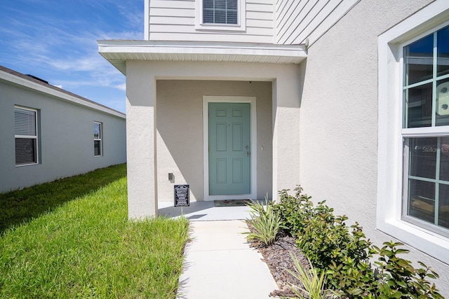 5031 Starboard St, Haines City, FL 33844 - property entrance with a lawn and stucco siding