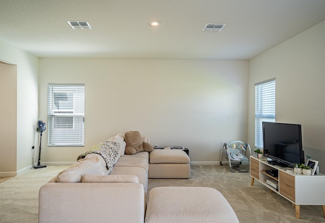 5031 Starboard St, Haines City, FL 33844 - living room with baseboards, light carpet, and visible vents