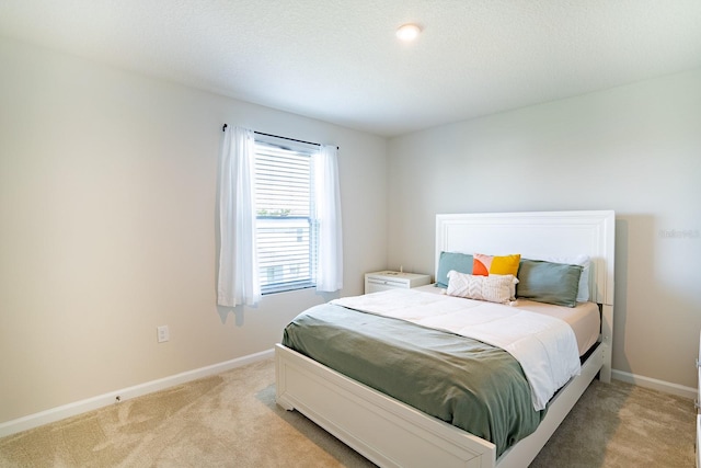 carpeted bedroom featuring a textured ceiling