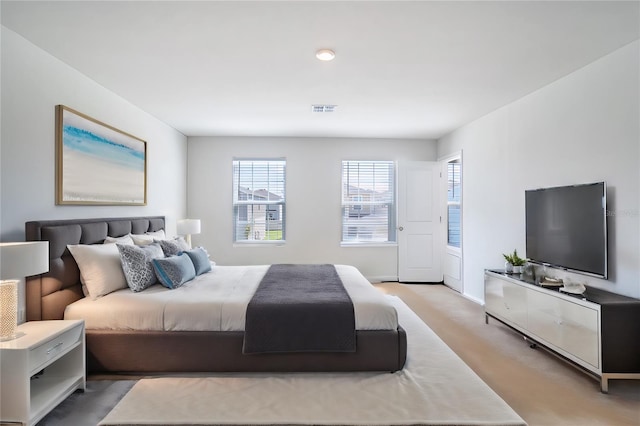 bedroom with light colored carpet