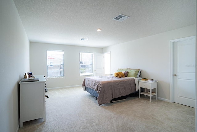 carpeted bedroom featuring a textured ceiling