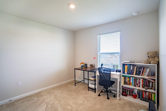 office area with light carpet and a textured ceiling