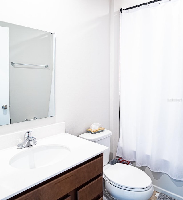 full bathroom featuring vanity, toilet, and shower / bath combination with curtain