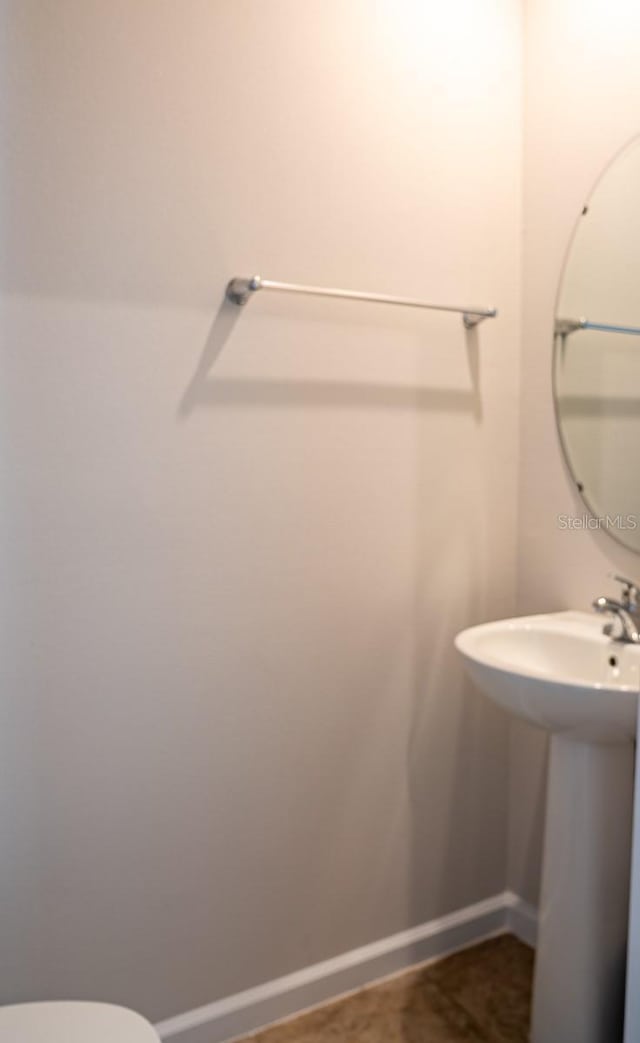 5031 Starboard St, Haines City, FL 33844 - half bathroom with baseboards, a sink, and toilet