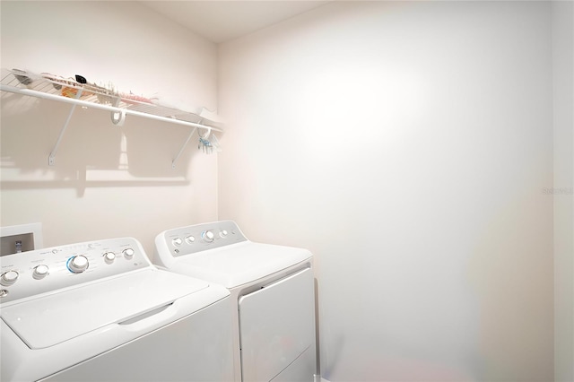 clothes washing area with washer and dryer