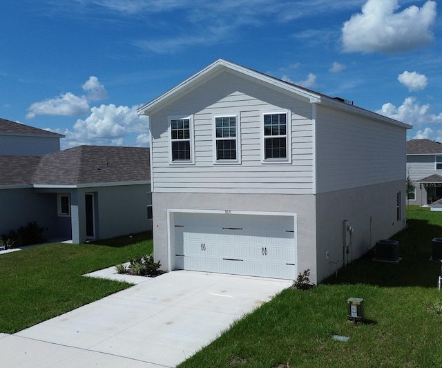 view of front of house with a front yard, central AC unit, and a garage