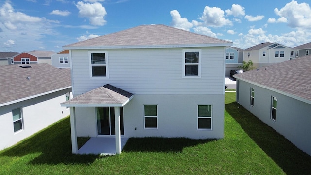 5031 Starboard St, Haines City, FL 33844 - back of house featuring a yard, a patio area, and roof with shingles