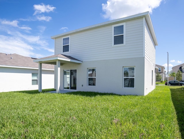 5031 Starboard St, Haines City, FL 33844 - rear view of house featuring stucco siding and a yard
