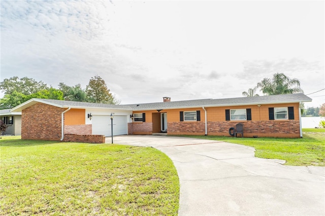 single story home featuring a garage and a front yard